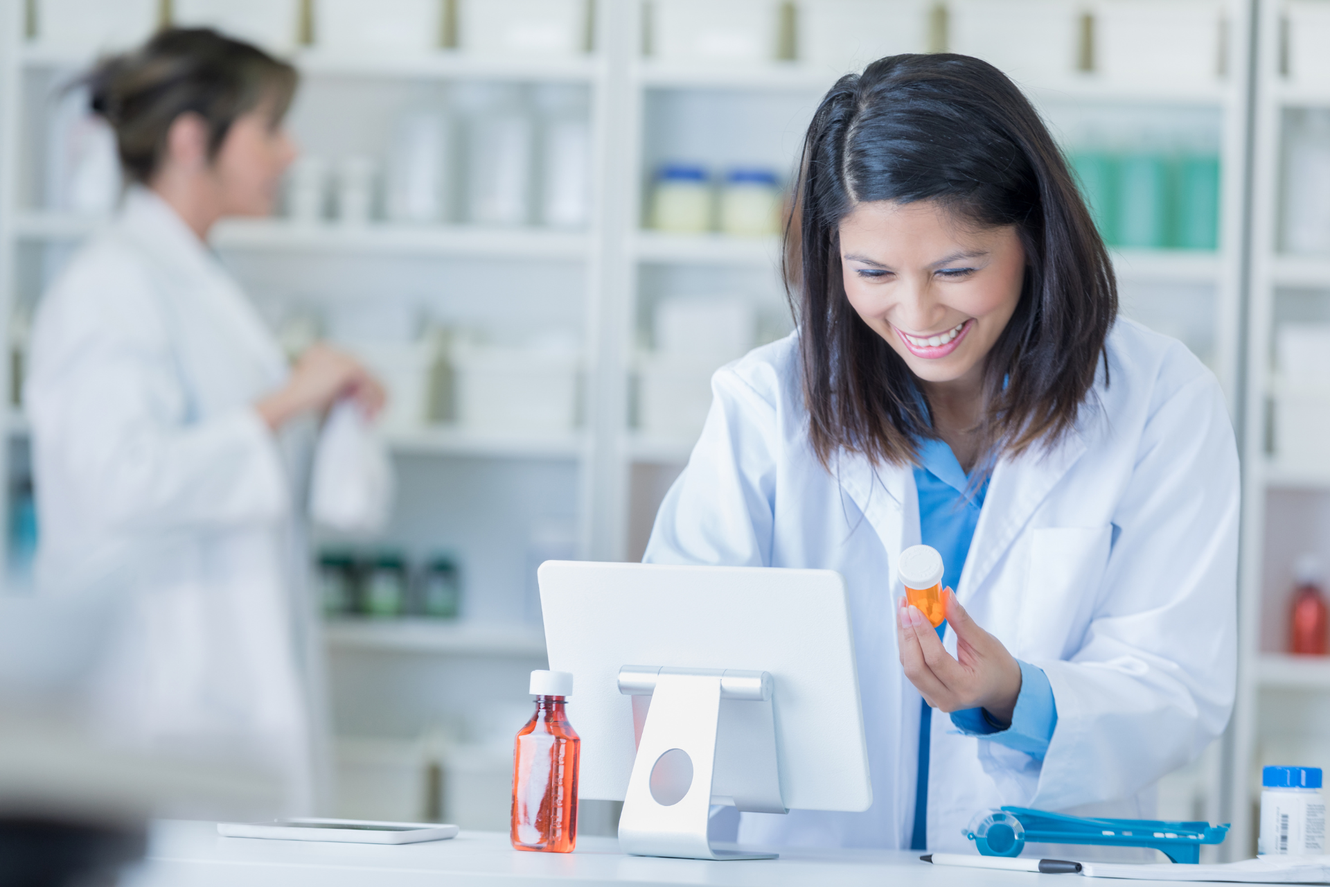 Pharmacist with bottle and tablet Pharmacist with bottle and tablet